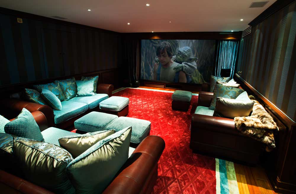 Home cinema with screen, curtains and projector.