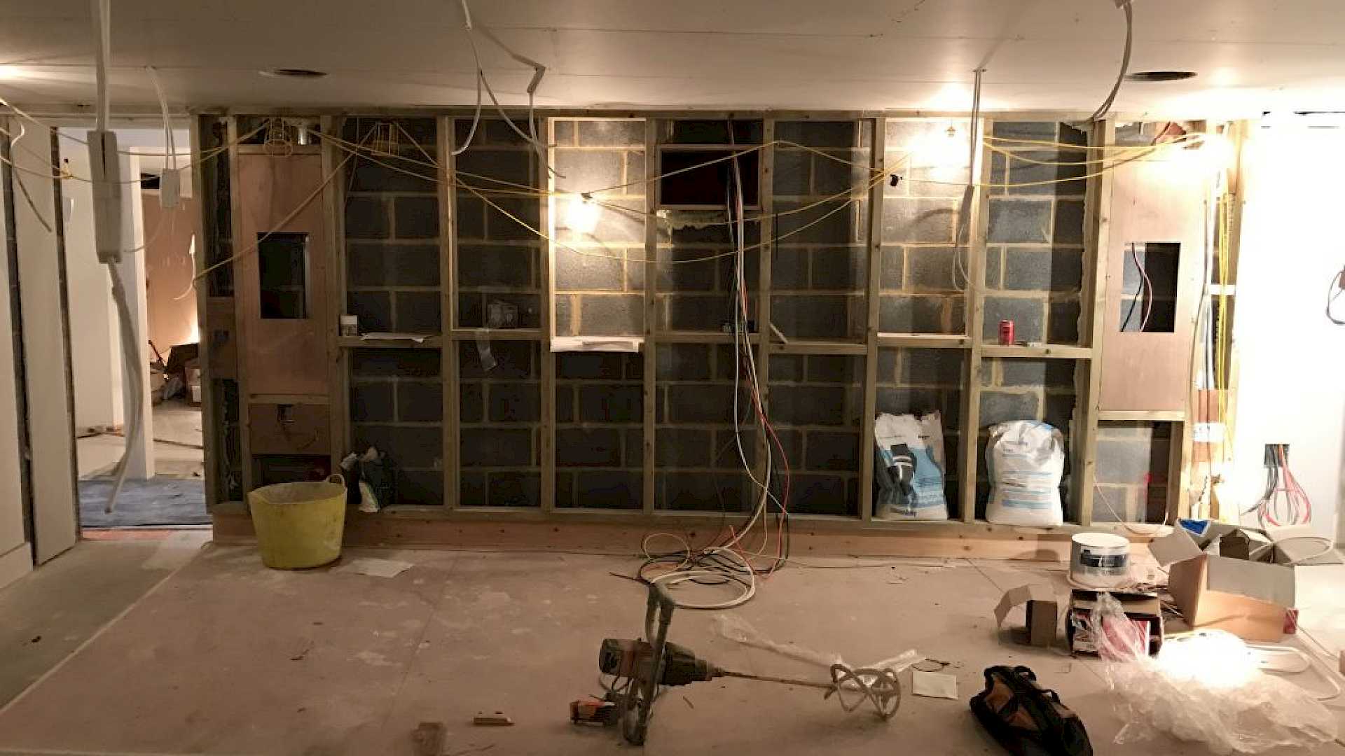 Image shows construction of rear wall of home cinema and wiring.