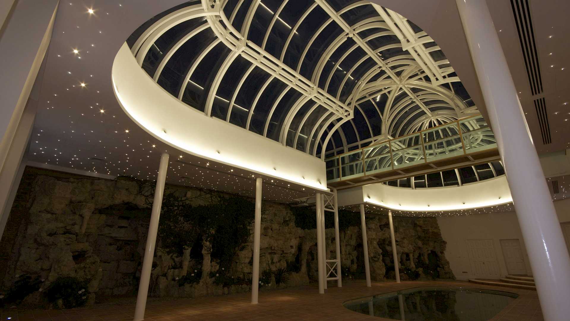 Shows Crestron lighting in winter garden, with pool