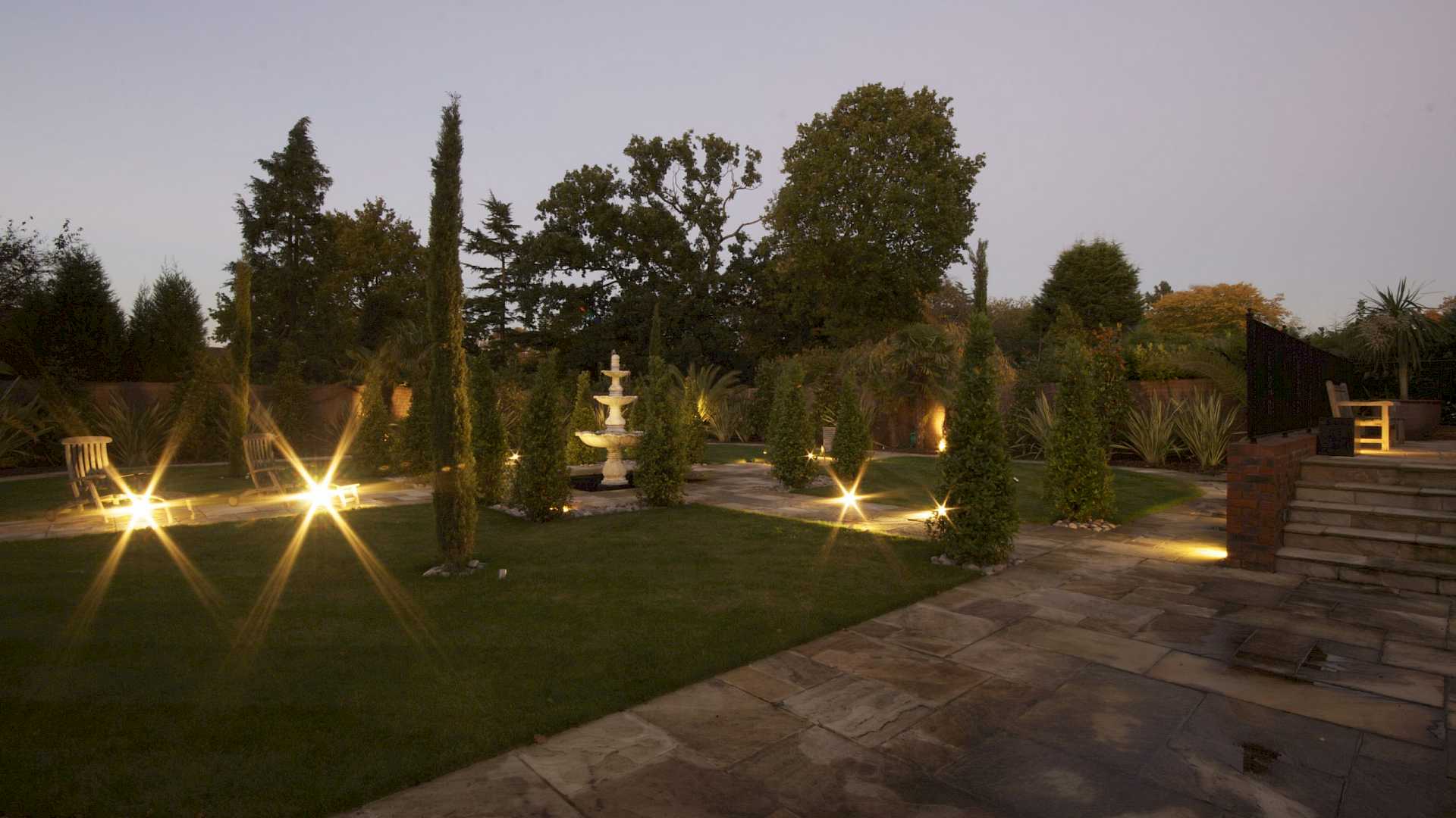 Outside lighting in this Kent home, with low level path lights, accept lights and patio lighting