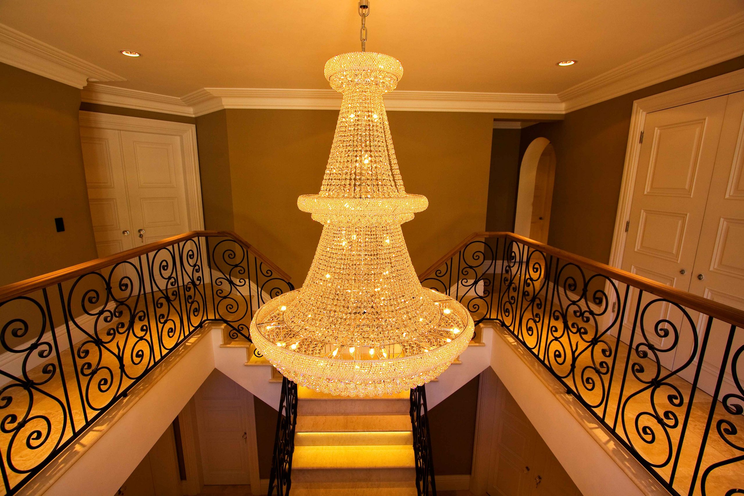 Hall lighting with large chandelier, controlled by lighting system