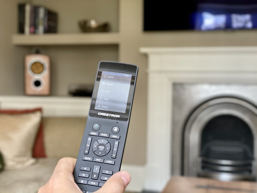 Crestron touchpanel remote being used to control media room.
