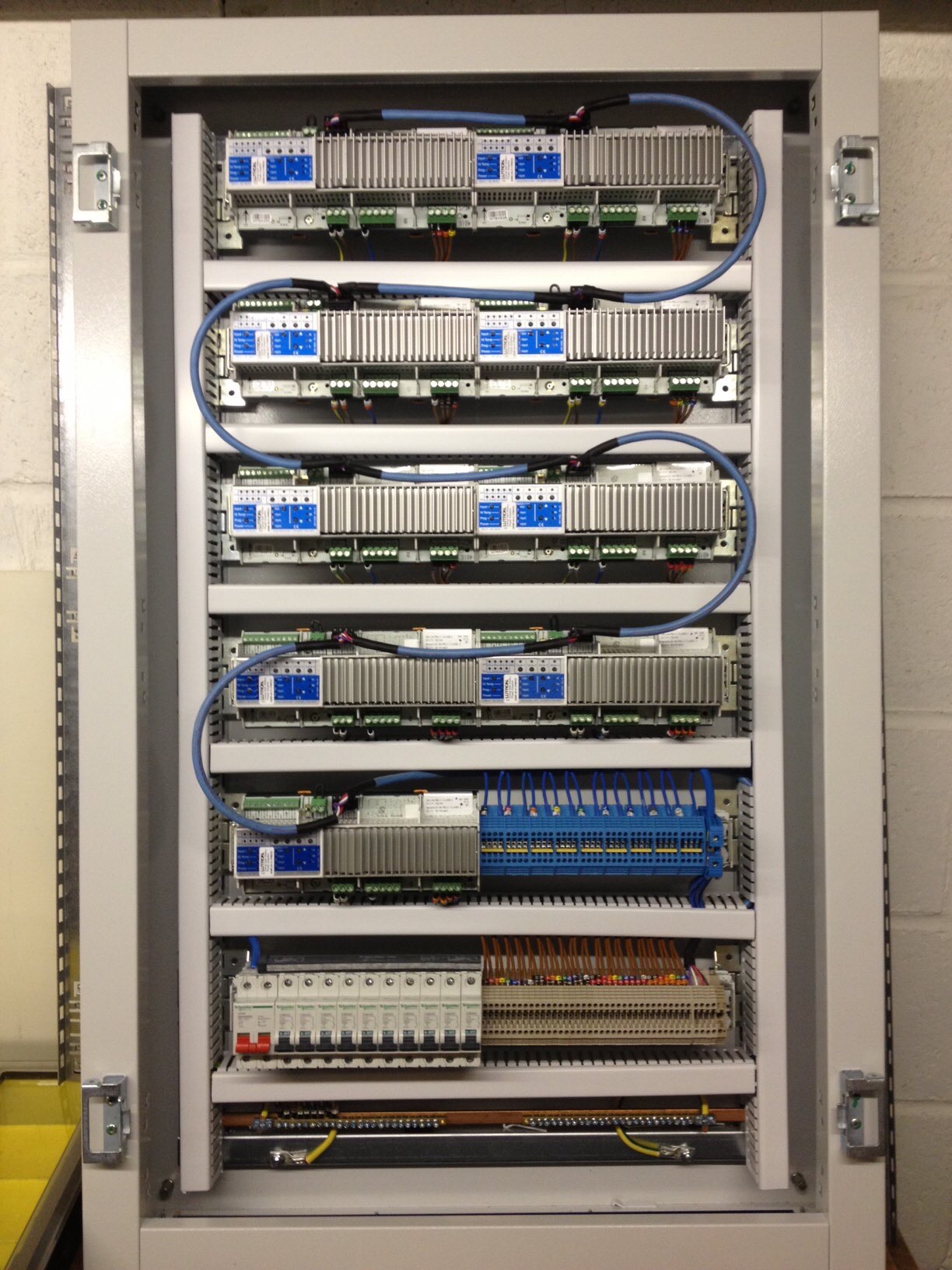 Shows a bespoke lighting control panel with Lutron dimming modules.
