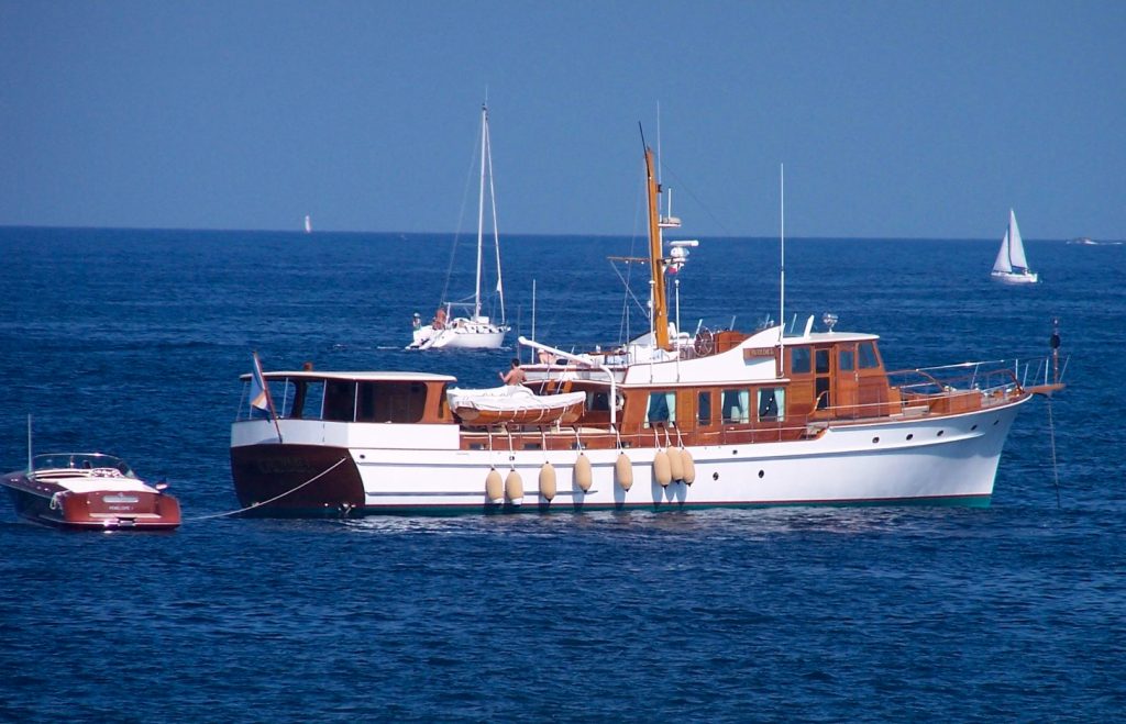 Shows yacht at sea, with marine audio visual system including video server, cinema and audio system.