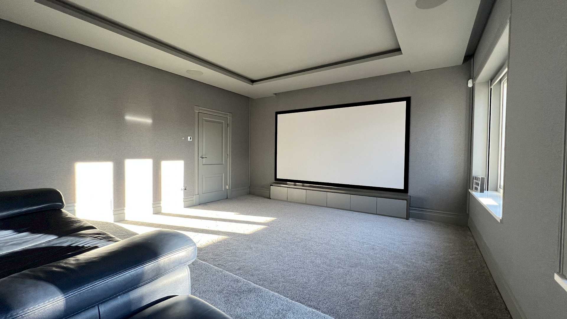 Daytime view of home cinema, with motorised blinds up