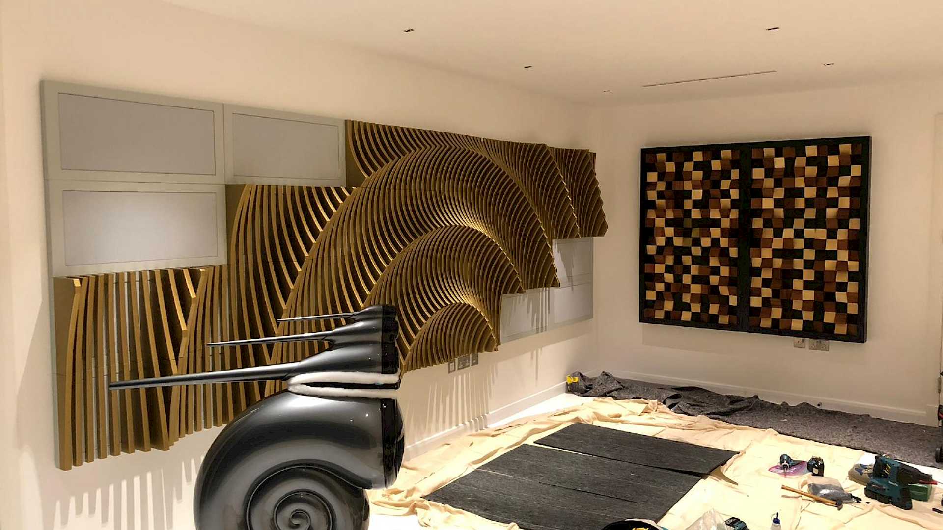 Shows installation of acoustic room treatment in ammonite room, with B&W Nautillus speaker.