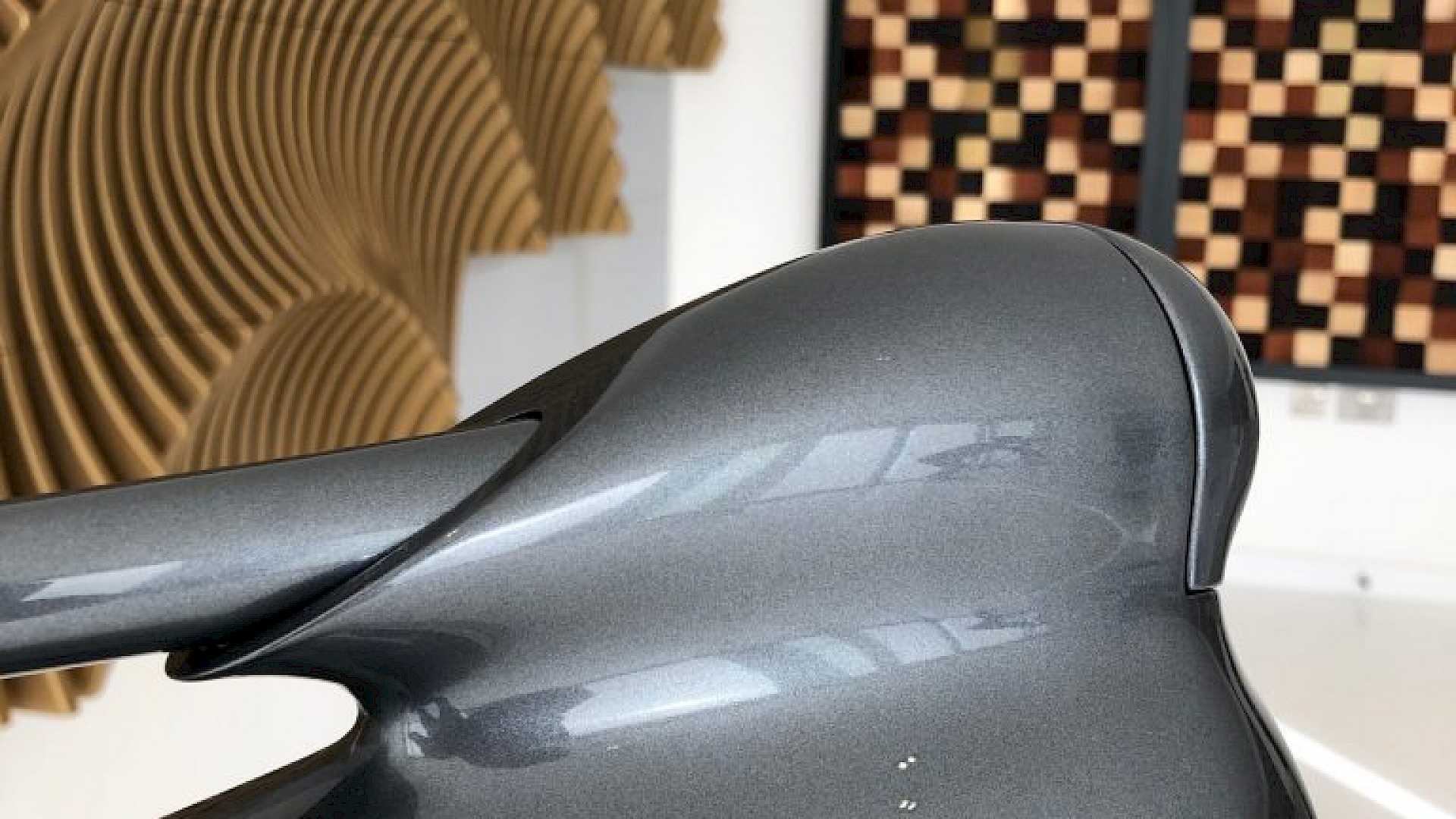 Bowers and Wilkins Nautillus loudspeaker with acoustic room treatment in background.