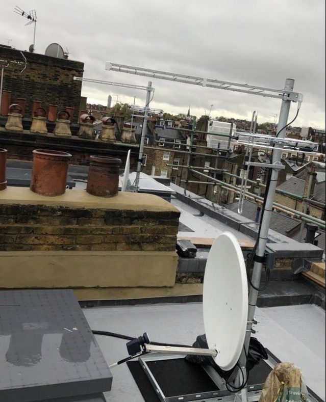 Satellite TV system on roof, showing aerials and satellite dish.